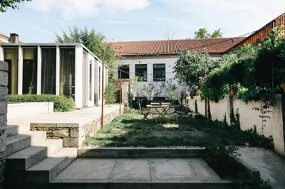 a house with a garden in front of it at Inferniño Apartments in Santiago de Compostela
