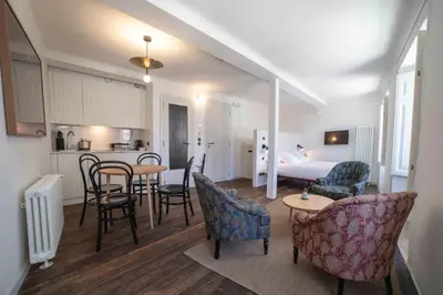 a living room with a bed and a table and chairs at Inferniño Apartments in Santiago de Compostela