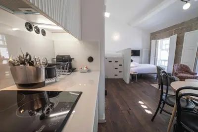 a kitchen with a stove and a dining room at Inferniño Apartments in Santiago de Compostela