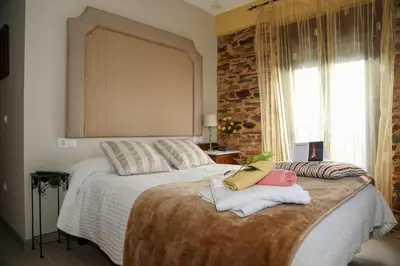 a bedroom with a bed with two towels on it at A Lume Manso - Adults Only in Barreiros
