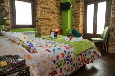 a bedroom with a bed with a comforter on it at A Lume Manso - Adults Only in Barreiros