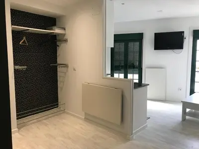 a room with a closet with a tv on a wall at A Casiña do Leo in Ourense