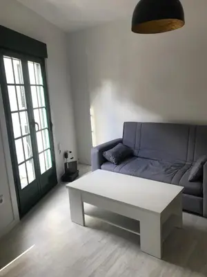 a living room with a couch and a coffee table at A Casiña do Leo in Ourense