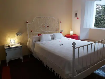a bedroom with a white bed and a window at Camino de Estrellas Mondoñedo Lugo in Mondoñedo