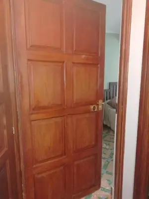 a wooden door in a room with a bed at Camino de Estrellas Mondoñedo Lugo in Mondoñedo