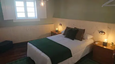 a bedroom with a bed with two lights on it at Camino de Estrellas Mondoñedo Lugo in Mondoñedo