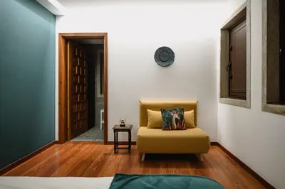 a living room with a chair and a door at Finca BRIABÍ in La Cañiza