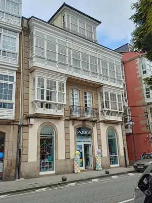 a building with balloons in front of it on a street at A&L Centro in Viveiro