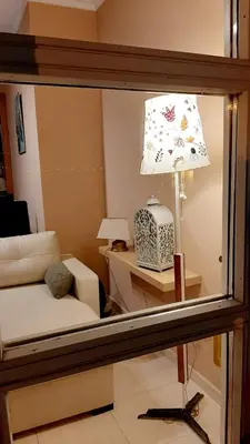 a reflection of a living room with a lamp in a mirror at A&L Centro in Viveiro
