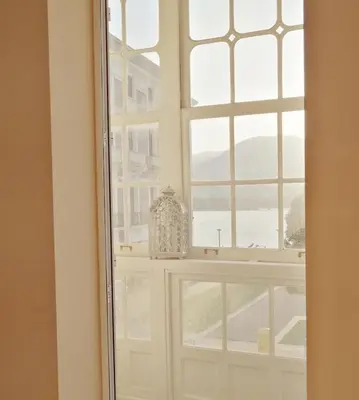 a mirror in a room with a window at A&L Centro in Viveiro