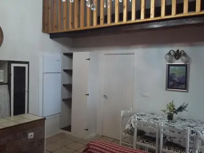 a dining room with a table and a staircase at Casiña de Folgosa in Ribadeo