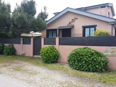 a house with a fence and some bushes at Casiña de Folgosa in Ribadeo
