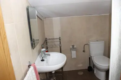 a bathroom with a sink and a toilet at Casa Dana in Santiago de Compostela