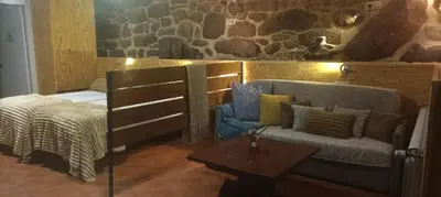 a room with a bed and a couch and a table at Apartamento do Xurés in Maus de Salas