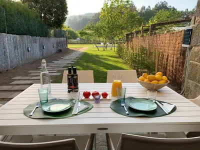 a white table with a bowl of fruit on it at Casa Herreria in Caldas de Reis