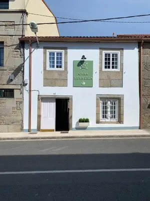 a white building on the side of a street at Casa Herreria in Caldas de Reis