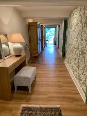 a hallway of a home with a desk and a chair at Casa Herreria in Caldas de Reis