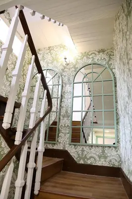 a staircase in a house with two windows at Casa Herreria in Caldas de Reis