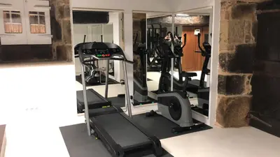 a gym with two tread machines and a mirror at Pazo de Laia in Palas de Rei