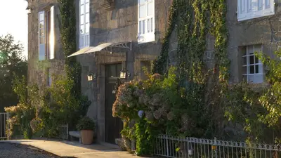 a building with ivy growing on the side of it at Pazo de Laia in Palas de Rei