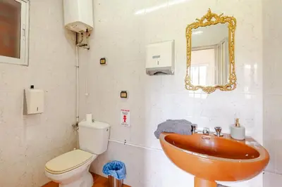 a bathroom with a sink and a toilet and a mirror at Casa Mosteiro in Bribes