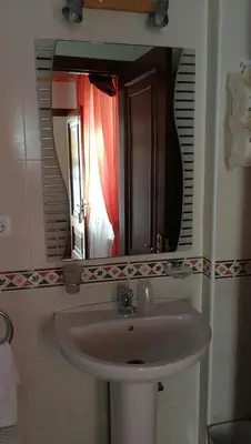 a bathroom with a sink and a mirror at Casa David in Tríacastela