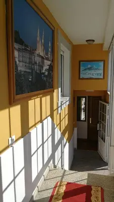 a hallway with a painting of a castle on the wall at Casa David in Tríacastela