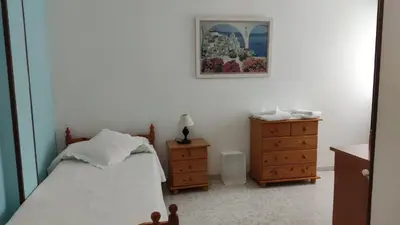 a bedroom with a bed and a dresser and a picture at Casa David in Tríacastela