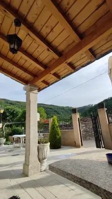 a wooden pergola with a table and chairs on a patio at Casa David in Tríacastela
