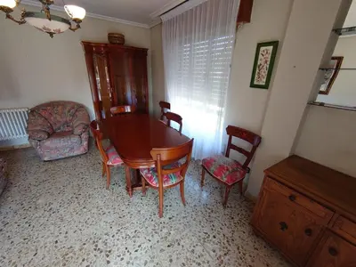 a dining room with a wooden table and chairs at HOSTAL CAMELOT in Fabero