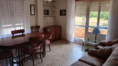 a living room with a table and chairs and a couch at HOSTAL CAMELOT in Fabero