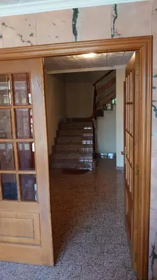 an open door to a room with a staircase at HOSTAL CAMELOT in Fabero