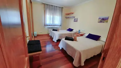 a hotel room with two beds and a window at Estrella Do Camiño in Caldas de Reis