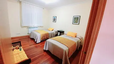 a room with two beds and a window at Estrella Do Camiño in Caldas de Reis