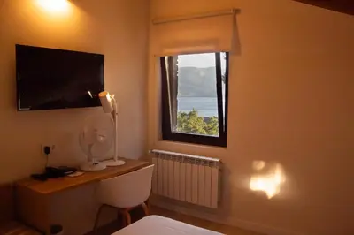 a room with a window and a toilet in a room at Villa Lucerna Sports & Hotel Resort in Vigo de Sanabria