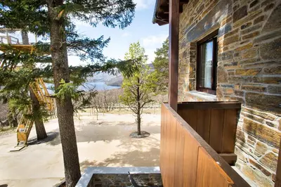 a view from the porch of a house with a tree at Villa Lucerna Sports & Hotel Resort in Vigo de Sanabria