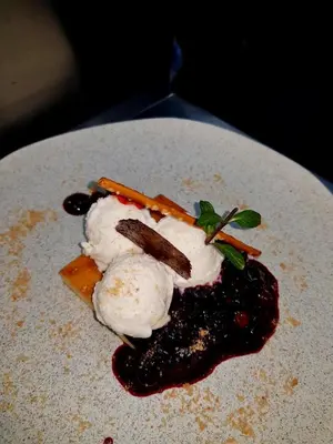 a plate of food with ice cream and sauce at Villa Lucerna Sports & Hotel Resort in Vigo de Sanabria