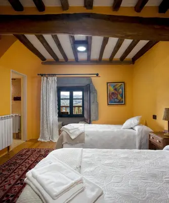 a bedroom with two beds and a window at Casa Vistaboa Ribeira Sacra in Chantada