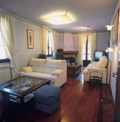 a living room with a white couch and a table at Casa Suarna in Navia de Suarna