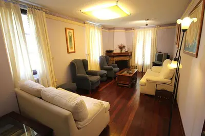 a living room with a white couch and chairs at Casa Suarna in Navia de Suarna