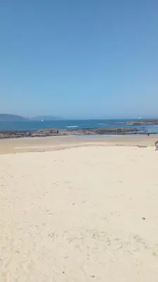 a sandy beach with the ocean in the background at CHALET CON PISCINA EN MIÑO-Perbes in Miño