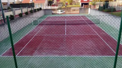 a tennis court with two tennis courts at CHALET CON PISCINA EN MIÑO-Perbes in Miño