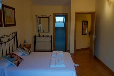 a bedroom with a bed with two towels on it at CHALET CON PISCINA EN MIÑO-Perbes in Miño