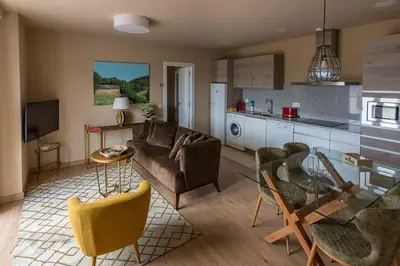 a living room with a couch and a glass table at Apartamentos Buenavista Tineo in Tineo