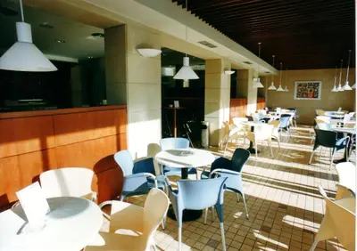 a restaurant with white tables and chairs and tables and tablesktop at Hotel Sarga in Cabañas