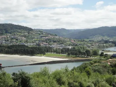 a view of a river and a town at Hotel Sarga in Cabañas