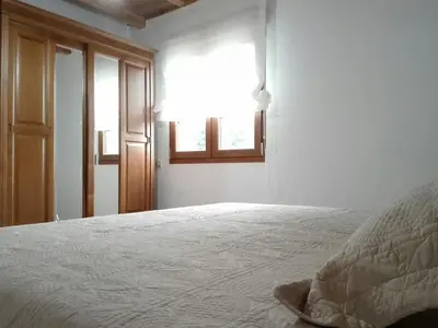 a bedroom with a bed and a window at Casa de aldea Amezaga in Taramundi