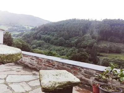 a stone ledge with a view of a mountain at Casa de aldea Amezaga in Taramundi