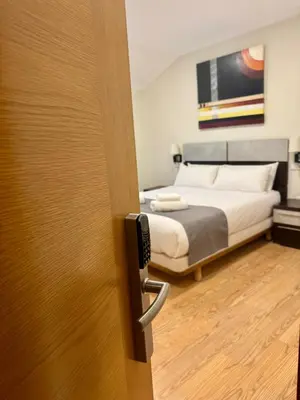 a door leading to a bedroom with a bed at Hotel Reigosa in Pontevedra
