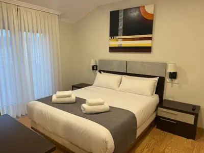 a bedroom with a bed with two towels on it at Hotel Reigosa in Pontevedra
